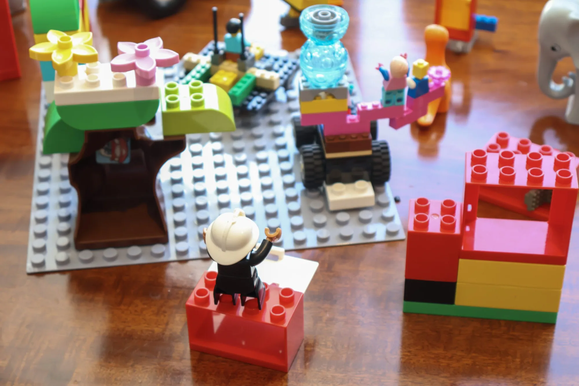 A team celebrating a moment of clarity and shared success with LEGO bricks.