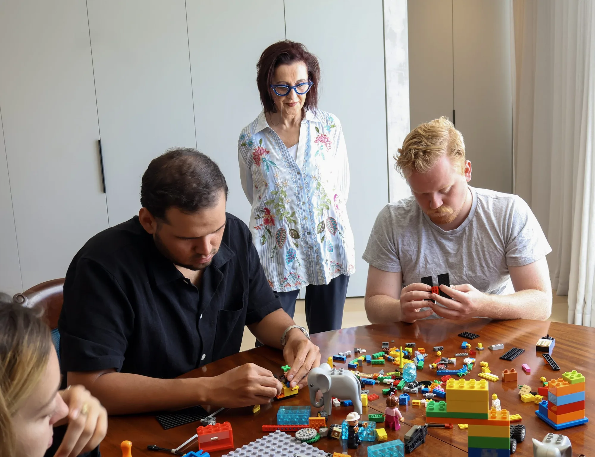 A facilitator guiding a group through a structured build process.
