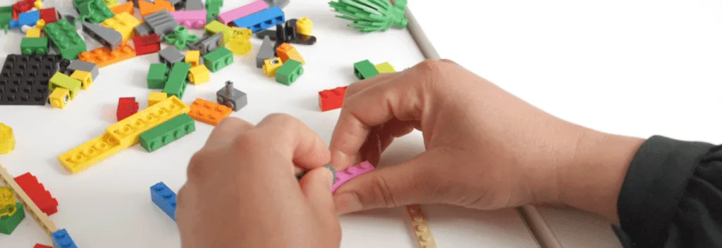 Participants using LEGO® Serious Play® Method to build creative models for innovative problem-solving and business growth.