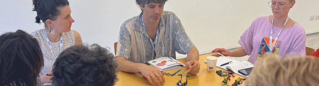 Leaders building a shared LEGO model to make sense of complex systems.