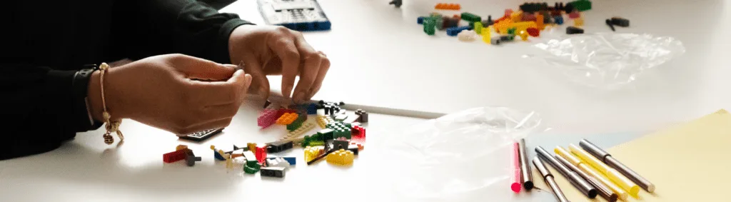 LEGO models on a table representing strategic thinking and team collaboration.